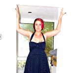 Pic of Older redhead Sara Banks shows her tits and pussy at home in white nylons