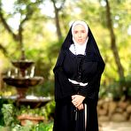 Pic of Thick Nun exposes herself in the courtyard wearing over the knee socks