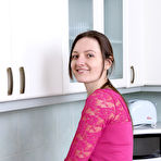 Pic of Slender brunette housewife Mariona strips to spread hairy pussy in the kitchen