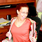 Pic of Redheaded businesswoman Misty Haze gets naked for a finger fuck in her office