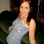 Pic of Young redhead gets naked on a sofa while wearing running shoes