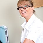 Pic of Lusty mature office lady revealing her big melons and inviting twat