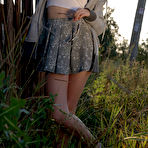 Pic of Long haired teen Hrizantema strips to her sneakers by a tree in a field