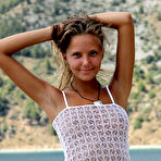 Pic of Solo girl Mango A modeling naked on rocky beach after disrobing