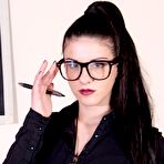 Pic of Nerdy chick Bianca frees her hose covered feet from heels at her desk