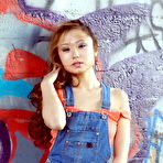 Pic of Petite Asian teen Gretchen stands naked against a graffiti covered wall