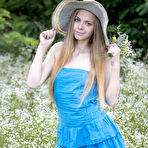 Pic of Petite teen Nastyshka doffs a sun hat and dress to pose nude in a field