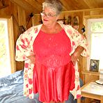 Pic of Short haired granny Girdle Goddess stripping to her stockings and high heels