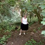 Pic of Mature amateur whore Caro masturbating on the bench in the woods