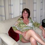 Pic of Mature lady Cassandra Uk slides her panties aside after showing her nipples