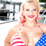 Pic of European stunner with huge fake boobs plays an erotic solo near a yacht
