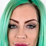 Pic of Tattooed girl with green hair and pierced nipples stands naked after disrobing