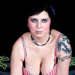 Pic of Tatted girl Fallen Angel fingers her bald pussy after showing her natural tits