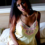 Pic of Sexy Indian girl uncovers round boobs as she slips off satin lingerie