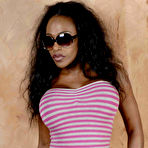 Pic of Ebony model Feline Wood plays with her long hair while wearing sunglasses