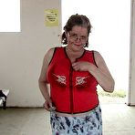 Pic of Older redhead Misha MILF displays her large tits by a lake before dildo riding