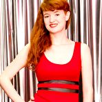 Pic of Young redhead Liz B touts her great boobs as she gets naked in solo action