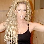 Pic of Blonde chick with curly hair sucks off a cock through a bathroom gloryhole