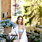Pic of Redheaded teen Atika cups her full breasts while baring her skinny body