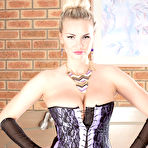 Pic of Hot MILF Marie Lambo frees her nice melons from her corset in back seam nylons