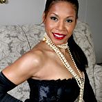 Pic of Ebony mature Semmie Desuora revealing her melons from a classy corset dress