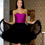 Pic of Brunette teen Alisa Amore doffs a corset and tutu skirt to model totally naked