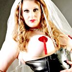 Pic of Redheaded bride sports nipple pasties in a black latex corset