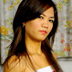 Pic of Slender Asian teen Petite Bunny holds her tight butt while showing her snatch