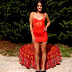 Pic of Brunette teen Bella Modele toys her spread pussy in a backyard setting