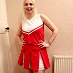 Pic of Blonde amateur Tracey Lain rides a cock on a bed in cheerleader attire