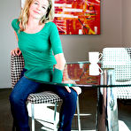 Pic of Sexy blonde MILF strips tight jeans to spread for shaved pussy closeup