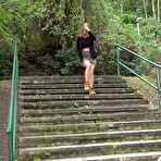 Pic of Natural redhead Chrissy Fox squats for a pee on a set of public steps