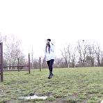 Pic of Dark-haired girl Shalina Shine takes a pee on a bench in a public field