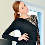 Pic of British model Sophia Smith wears her red hair in a ponytail while undressing
