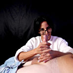 Pic of Brunette MILF Abi James removes her glasses while jerking on a massive cock