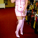 Pic of Blonde amateur Samantha works free of a latex nurse outfit in a sex shoppe
