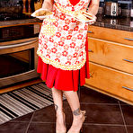 Pic of Stunning blonde MILF with red lips uncovering her goods in the kitchen