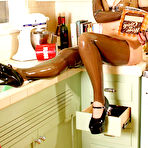 Pic of Kinky girl January Seraph wears rubber attire while cooking in a retro kitchen