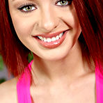 Pic of Cute redhead uncovers her large breasts while stripping off her clothing