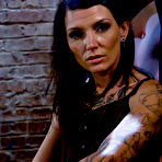 Pic of Tattoo brunette tortures a male slave's balls and cock in a dungeon