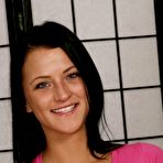 Pic of Brunette amateur Brandy Bates holds her bare ass after getting naked on a bed