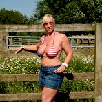 Pic of Busty mature slut Melody sheds bikini top outdoors to sun massive tits
