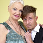 Pic of Short haired cougar has her large boobs licked by her young lover boy