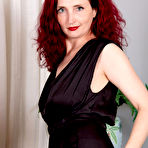 Pic of Classy mature redhead Zinnia Blue puts her pussy on display in sheer nylons