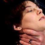 Pic of Brunette dyke is flogged by a man while restrained in a dungeon