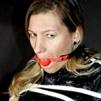 Pic of Caucasian girl is tied to a hairdresser's chair while ball gagged