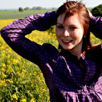 Pic of Redheaded teen pauses for a moment before getting naked in a field of crops