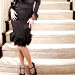 Pic of Raven-haired MILF in stockings undressing and spreading her legs