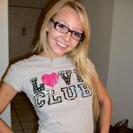 Pic of Blonde amateur Elle brushes her hair in glasses and thong while in a bathroom
