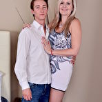 Pic of Middle aged woman shows her neighbor's boy the ways of sex in her bedroom